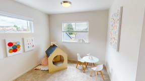 a childs play room with a tent and a table and chairs