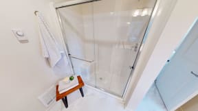 a shower with a glass door in a bathroom