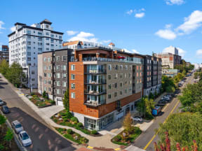 an aerial view of a large building with cars parked in front of it