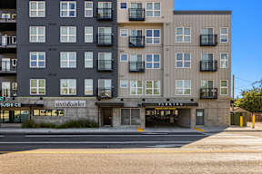 A multi-story building with a sushi restaurant on the ground floor.