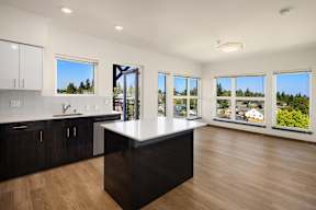 A kitchen with a large island in the middle of the room.