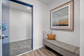 a living room with a couch and a door to a bathroom at Hue Apartments, Redmond