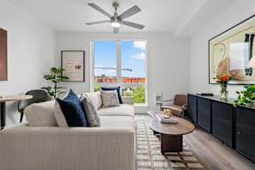an open living room with a couch and a ceiling fan at Hue Apartments, Washington, 98052