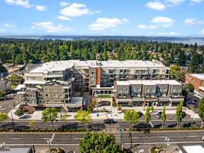 A large building with a parking lot in front of it.