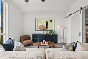 a living room with a couch and a chair and a table at Hue Apartments, Redmond , 98052