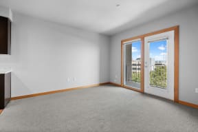 a room with a view of a hallway with columns and a door