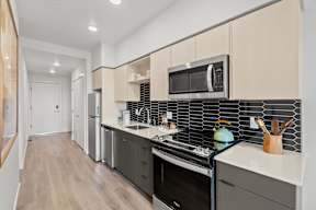 a kitchen with a sink and a stove and a microwave at Hue Apartments, Redmond