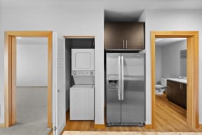 a kitchen with a refrigerator and a washer and dryer
