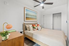 a bedroom with a bed and a ceiling fan at Hue Apartments, Redmond , WA