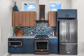 A kitchen with a blue and brown color scheme.