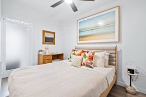 a bedroom with a large bed and a painting on the wall at Hue Apartments, Washington