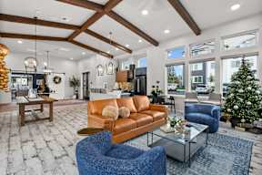 A living room with a blue chair and a brown couch.