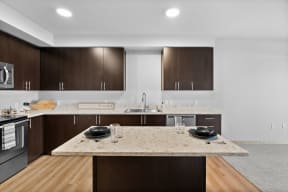 a kitchen with marble counter tops and wooden cabinets