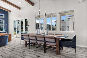 A dining room with a table set for four.