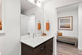 a bathroom with a large mirror and a sink at Hue Apartments, Washington, 98052