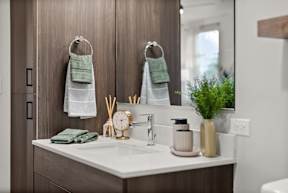 A bathroom with a white sink and a mirror.