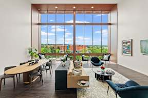 a living room with a large window and a table and chairs at Hue Apartments, Redmond , WA 98052