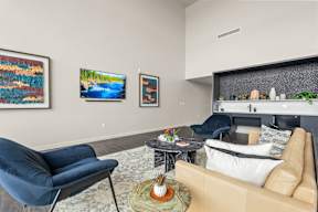 a living room with couches and chairs and a table at Hue Apartments, Redmond , WA