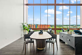 a room with a table and chairs in front of a window at Hue Apartments, Redmond , 98052