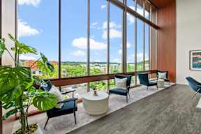 a room with a table and chairs in front of a window at Hue Apartments, Redmond , WA