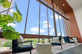 a living room with large windows and a table and chairs at Hue Apartments, Washington, 98052