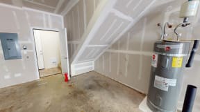a room under construction with a water heater and a door