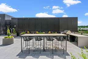 a bar on the roof of a building with bar stools at Hue Apartments, Redmond , 98052