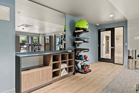 a helmet rack in a room with a mirror and a door at Hue Apartments, Washington