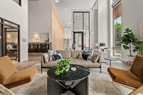 a living room with couches and a table at Hue Apartments, Redmond , 98052