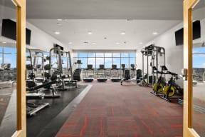 a gym filled with cardio equipment and windows