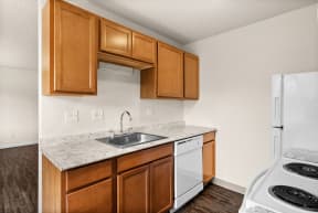a kitchen with white appliances and wooden cabinets and a sink and counter top