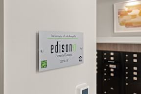 a white refrigerator with a sign on the door at Hue Apartments, Redmond , WA