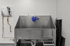 a large stainless steel sink in a white room at Hue Apartments, Redmond
