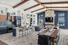 A modern kitchen with a dining table and chairs.
