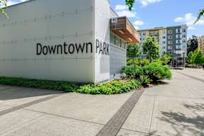 a sign for downtown park in front of a building at Hue Apartments, Washington