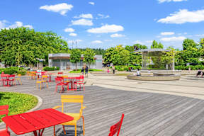 a park with tables and chairs and a fountain at Hue Apartments, Redmond , Washington