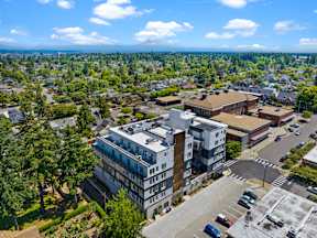 A large building with a parking lot in front of it.