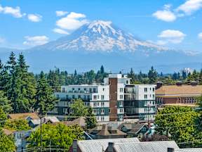 A mountain is in the background of a cityscape.