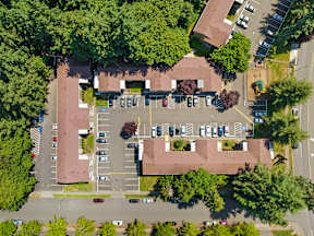 a birds eye view of a house in a parking lot