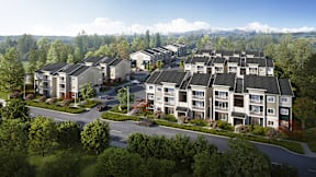 A large apartment complex with multiple buildings and a parking lot in the foreground.