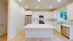 a large white kitchen with a white counter top