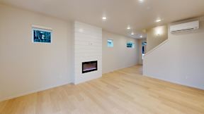 a living room with a fireplace and a wooden floor