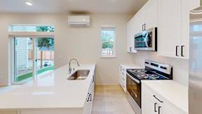 a modern kitchen with white cabinets and a sink