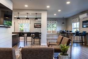A modern living room with a dining area and a kitchen in the background.