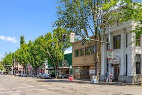 a street corner with a traffic light and a building on the corner