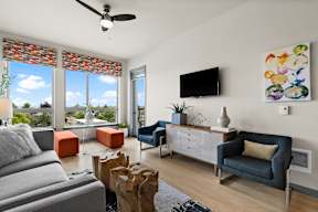 a living room with couches and chairs and a tv