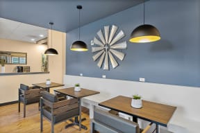 a dining room with tables and chairs and a clock on the wall