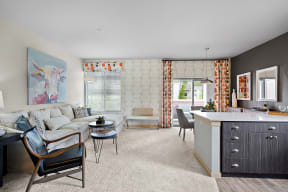 a living room with a white couch and a kitchen