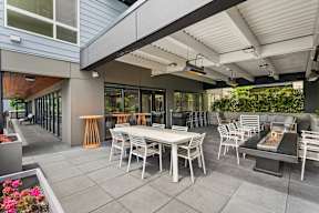 a patio with tables and chairs outside of a building