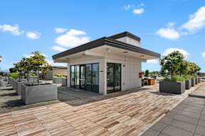 a building with glass doors and a wooden deck